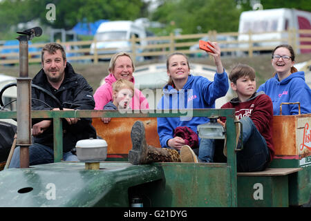 Royal Welsh Spring Festival, Sunday 22nd May 2016 - A farmer and his family pose for a selfie on their old farm vehicle as they wait for start of the classic vehicle and vintage tractor parade in the main display arena on the second day of the Royal Welsh Spring Festival.