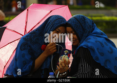 An Indonesian domestic helpers skyping with their family back home on the weekend. 22nd May, 2016. A bondage with the families are exceptionally strong as they are making hard-earned money overseas supporting their families in Indonesia. May 22, 2016. Hong Kong. Liau Chung Ren/ZUMA © Liau Chung Ren/ZUMA Wire/Alamy Live News Stock Photo