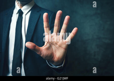 Businessman with long fingers, concept of relation between body parts and intelligence Stock Photo