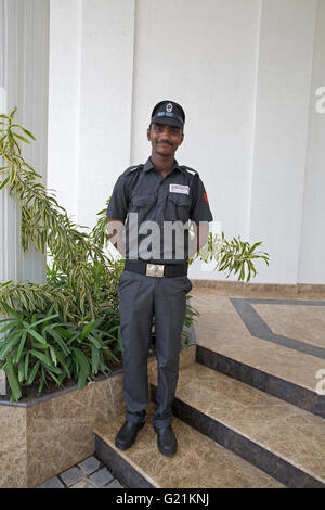 A security guard on duty outside the Fragrant Nature Hotel in Cochin India Stock Photo