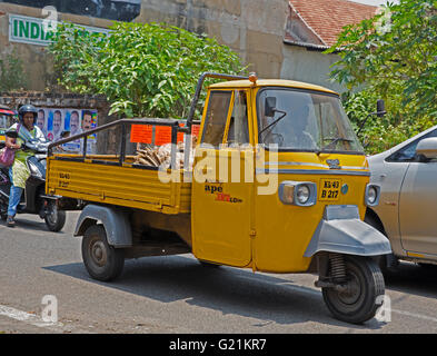 A three wheeler mini yellow van in Cochin India Stock Photo