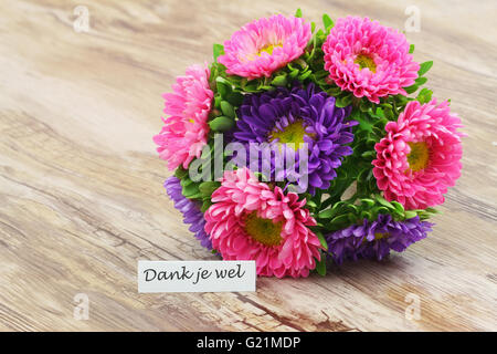 Dank je wel (which means thank you in Dutch) with colorful daisy bouquet Stock Photo