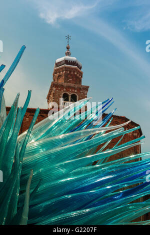 Detail of Blue Murano Glass Sculpture in Murano with San Giacomo Church in Background, Venice - Italy Stock Photo