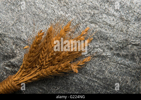 Dried wheat and straw on stone background Stock Photo