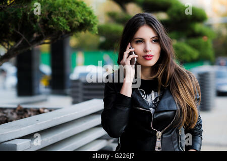Shot of student talking on the phone outdoors