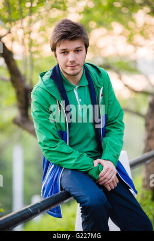Photo of a young man using smartphone at sunset Stock Photo
