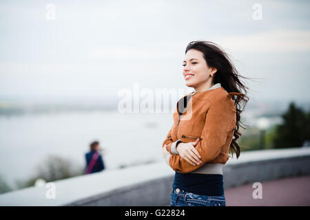 Happy young man browsing internet on smartphone sitting at outdoor cafe. Selective focus. Stock Photo