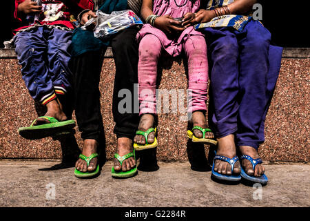 Homeless children sitting on a wall in Delhi, India, Stock Photo