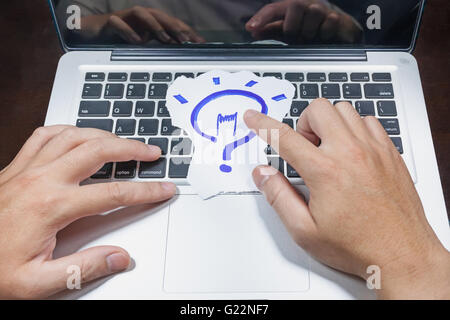 business, education, idea, inspiration and people concept - close up of male hands with paper sheet on computer keyboard Stock Photo