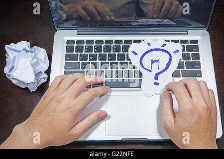 business, education, idea, inspiration and people concept - close up of male hands with paper sheet on computer keyboard Stock Photo