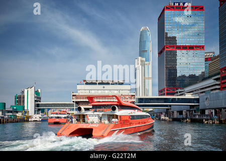 A red TurboJet ferry pulling into the Macao Ferry Terminal in Hong Kong Stock Photo