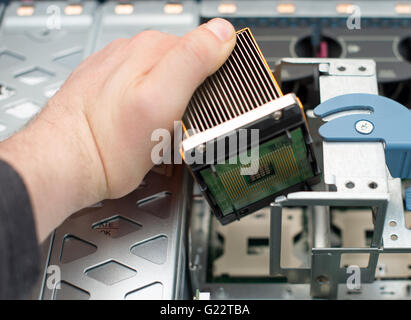 Computer technician installing CPU into motherboard. Stock Photo