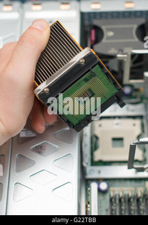 Computer technician installing CPU into motherboard. Stock Photo