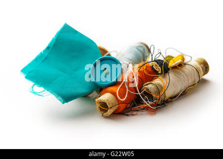 Sewing items with thread bobbins on white Stock Photo