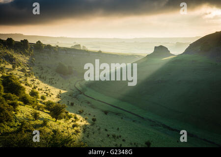 Cressbrook Dale, Peak District National Park. Derbyshire, UK. 23rd May, 2016. UK Weather: First light breaks over Peter's Stone and illuminates the banks of Cressbrook Dale, Derbyshire. A beautiful Spring morning in the Peak District National Park, England, UK. Credit:  Graham Dunn/Alamy Live News Stock Photo