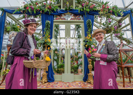 London, UK. 23rd May, 2016. Women from the National Association of Flower arangers in vintage dress on their stand - The opening day of the Chelsea Flower Show. Credit:  Guy Bell/Alamy Live News Stock Photo