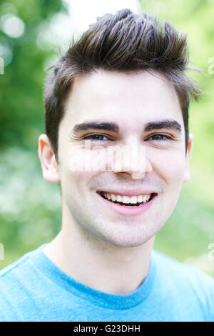Outdoor Head And Shoulders Portrait Of Smiling Young Man Stock Photo