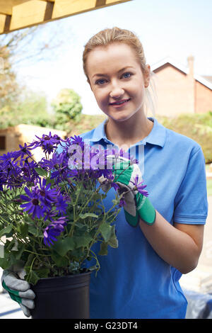 Portrait Of Female Landscape Gardener Holding Plant Stock Photo