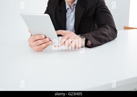 Cropped image of a businessman using tablet computer in the office Stock Photo