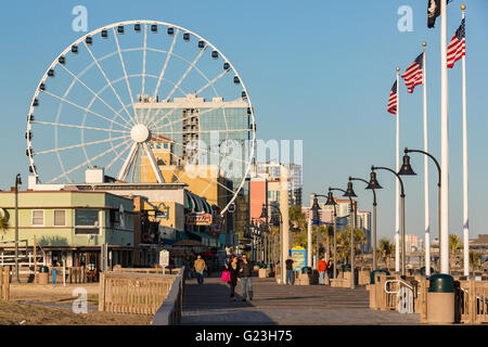 Oceanfront skyline of the boardwalk and Skywheel along the beach in Myrtle Beach, South Carolina. Stock Photo