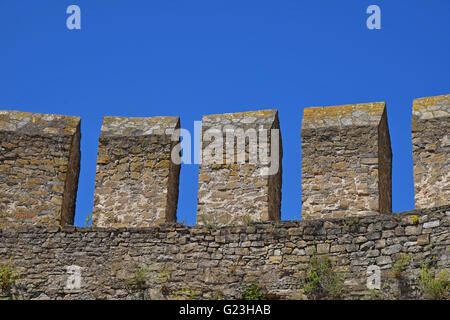 Medieval fortress or castle vallum, defensive stone wall over background of clear blue sky Stock Photo
