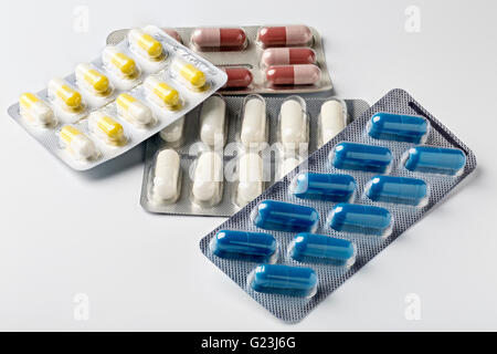 Pill blister pack with colorful capsules and pills on white background Stock Photo