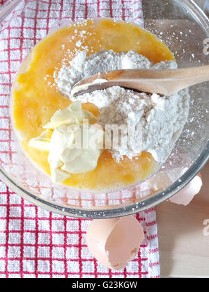 flour butter & egg in a mixing bowl Stock Photo