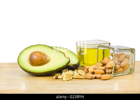 Healthy good fats with avocado, dry fruits and oil. Stock Photo