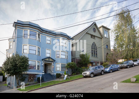 Historic apartment building and the 1907 wooden EUB Evangelical United Brethren Church on Queen Anne Hill in Seattle, Washington Stock Photo