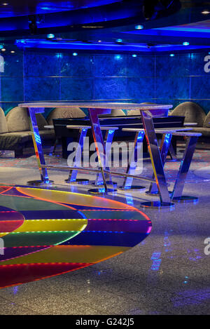 Restaurant with stone tables, brown leather chairs and blue light Stock Photo