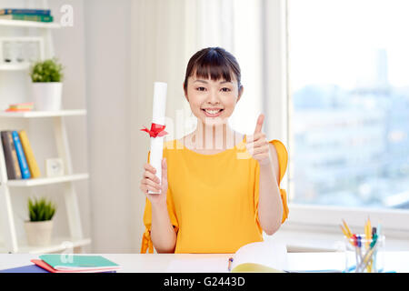 happy asian woman student with diploma at home Stock Photo