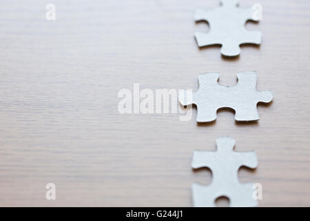 close up of puzzle pieces on wooden surface Stock Photo