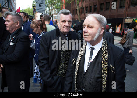 Teddy Boys gather outside a pub in Soho following a 40th anniversary of their infamous march on the BBC to protest that they wanted more rock and roll on the radio, which they recreated today on May 14th 2016 in London, United Kingdom. Teddy Boy, also known as Ted, is a British subculture typified by men wearing clothes that were partly inspired by the styles worn by dandies in the Edwardian period, which tailors had attempted to re-introduce in Britain after World War II. It is sometimes inaccurately written that the Teddy Boy style and phenomenon appeared in Britain during the mid 1950s as a Stock Photo