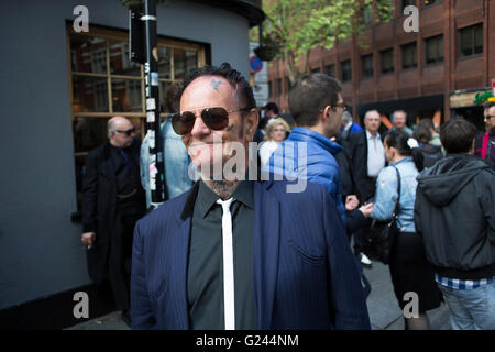 Teddy Boys gather outside a pub in Soho following a 40th anniversary of their infamous march on the BBC to protest that they wanted more rock and roll on the radio, which they recreated today on May 14th 2016 in London, United Kingdom. Teddy Boy, also known as Ted, is a British subculture typified by men wearing clothes that were partly inspired by the styles worn by dandies in the Edwardian period, which tailors had attempted to re-introduce in Britain after World War II. It is sometimes inaccurately written that the Teddy Boy style and phenomenon appeared in Britain during the mid 1950s as a Stock Photo