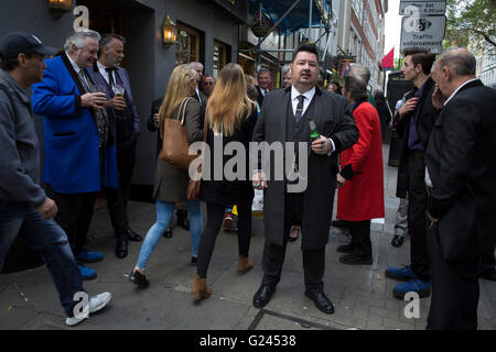 Teddy Boys gather outside a pub in Soho following a 40th anniversary of their infamous march on the BBC to protest that they wanted more rock and roll on the radio, which they recreated today on May 14th 2016 in London, United Kingdom. Teddy Boy, also known as Ted, is a British subculture typified by men wearing clothes that were partly inspired by the styles worn by dandies in the Edwardian period, which tailors had attempted to re-introduce in Britain after World War II. It is sometimes inaccurately written that the Teddy Boy style and phenomenon appeared in Britain during the mid 1950s as a Stock Photo