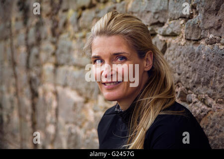 Middle aged female runner smiles for the camera. Close up. Stock Photo