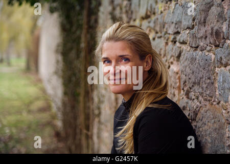 Middle aged female runner smiles for the camera. Close up. Stock Photo