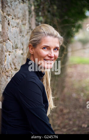 Middle aged female runner smiles for the camera. Close up. Stock Photo