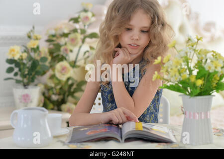 Young little girl reading a magazine Stock Photo