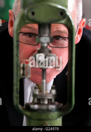 Deputy First Minister and Education Secretary John Swinney views a diaphragm control valve during a visit to Forth Valley College where he met staff, students and apprentices. Stock Photo