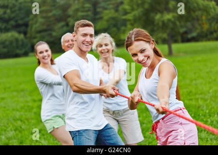 Strong group in a competition playing tug of war Stock Photo