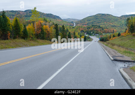 Autumn endless road under cloudscape, Quebec, Canada Stock Photo - Alamy