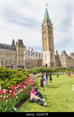 Two friends  taking selfies in front of the Canadian Parliament Centre Block in Ottawa Stock Photo