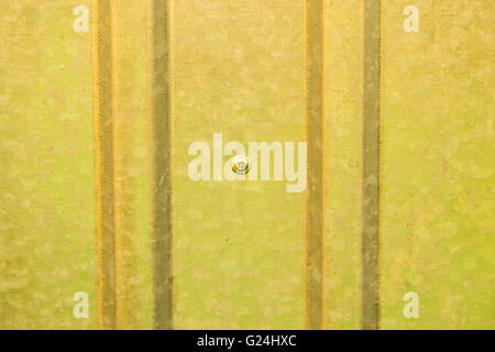 Corrugated yellow metal sheet wall Stock Photo