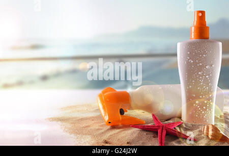 Two suncream with starfish and shell on sand in glass table in terrace overlooking beach and sun shine. Horizontal composition. Stock Photo