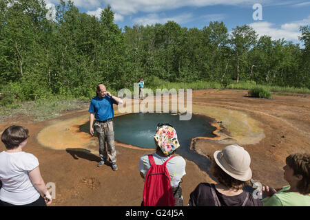 Group of tourists at hot spring in Nalychevo Nature Park in summer on a sunny day. Kamchatka Peninsula, Russian Far East. Stock Photo