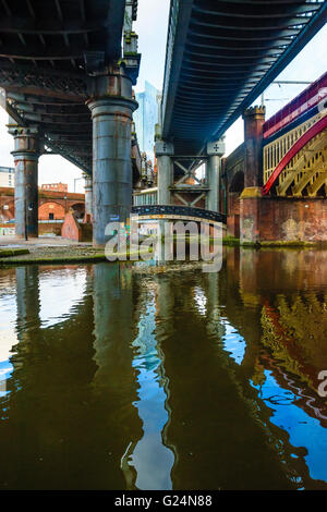 The Beetham Tower appears between bridges in the regeneration area of Castlefield Manchester Stock Photo