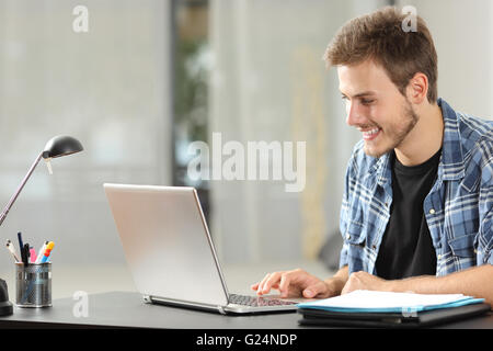 Entrepreneur or student man working or studying using a laptop on a desk at home Stock Photo