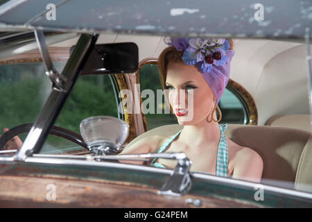 woman driving vintage car staring ahead Stock Photo