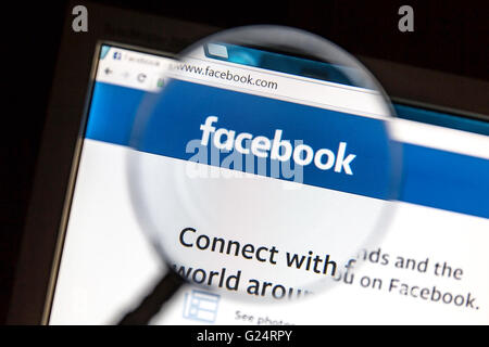Facebook website under a magnifying glass. Facebook is the most visited social network in the Stock Photo